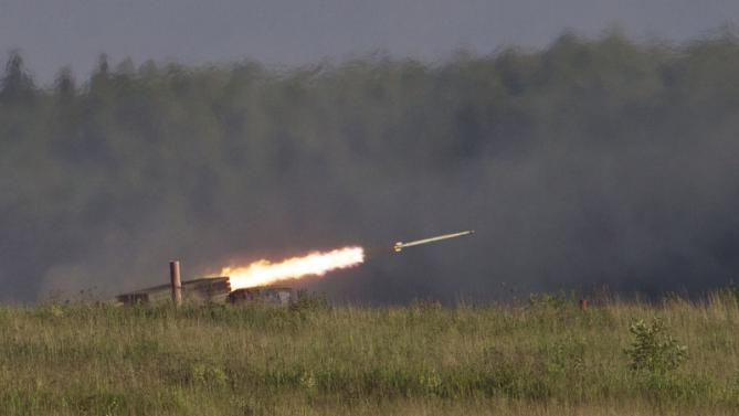 Russian Tornado-G multiple rocket launcher  drives during the Army-2015 show at a shooting range in Alabino, outside of Moscow, Russia, on Tuesday, June 16, 2015. Russia’s military this year alone will receive over 40 new intercontinental ballistic missiles capable of piercing any missile defences, President Vladimir Putin said Tuesday in a blunt reminder of the nation’s nuclear might amid tensions with the West over Ukraine. (AP Photo/Ivan Sekretarev)