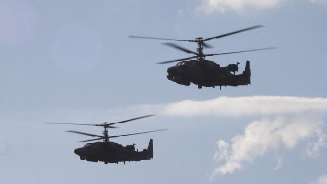 Russian Army&#39;s KA-52 helicopters fly during the Army-2015 show at a shooting range in Alabino, outside of Moscow, Russia, on Tuesday, June 16, 2015. Russia’s military this year alone will receive over 40 new intercontinental ballistic missiles capable of piercing any missile defences, President Vladimir Putin said Tuesday in a blunt reminder of the nation’s nuclear might amid tensions with the West over Ukraine. (AP Photo/Ivan Sekretarev)