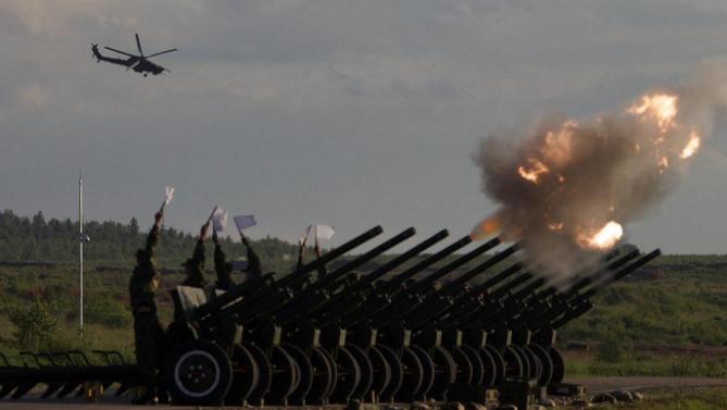 Russian Army&#39;s MI-28 attack helicopter flies as salute cannons fire during a show at a shooting range in Alabino, outside of Moscow, Russia, on Tuesday, June 16, 2015. Russia’s military this year alone will receive over 40 new intercontinental ballistic missiles capable of piercing any missile defences, President Vladimir Putin said Tuesday in a blunt reminder of the nation’s nuclear might amid tensions with the West over Ukraine. (AP Photo/Ivan Sekretarev)