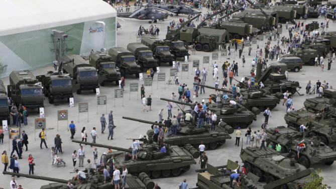 Visitors walk near exhibits, which are on display at the Army-2015 international military-technical forum in Kubinka