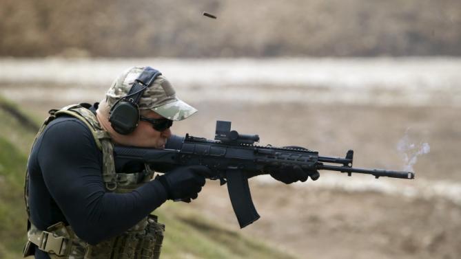 A participant fires a Kalashnikov AK-12 assault rifle at the Army-2015 international military-technical forum in Kubinka